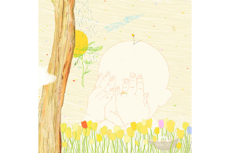 A child covering his eyes smiling in the filed of flowers